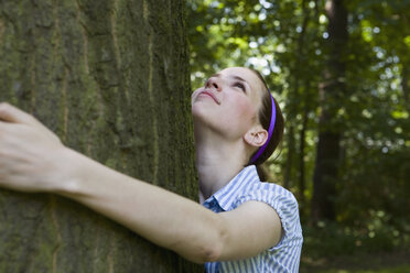 A young woman hugging a tree - FSIF02692