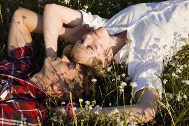 A young couple napping in a field - FSIF02720