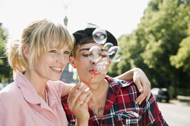 A young couple blowing bubbles - FSIF02741