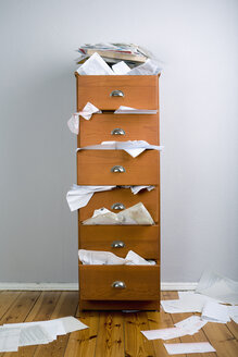 A cabinet stuffed with overflowing papers - FSIF02864