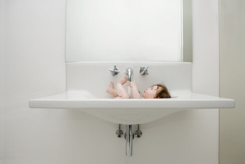 A baby taking a bath in sink - FSIF02915