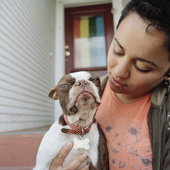 A woman holding her dog - FSIF02955