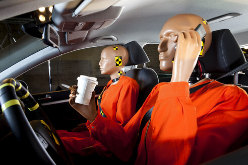 A crash test dummy carelessly using a mobile phone while driving with a crash test dummy passenger - FSIF03009