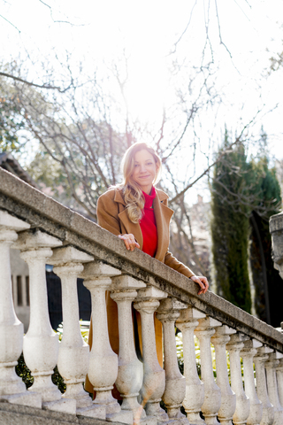 Portrait of smiling young woman in a public garden stock photo