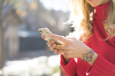 Close-up of woman using smartphone in a garden - AFVF00182