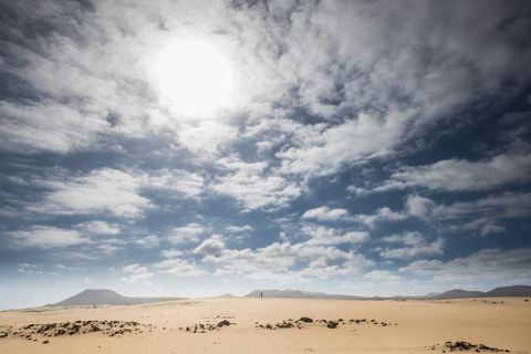 Spain, Canary Islands, Fuerteventura, Parque Natural de Corralejo, small person standing on dune stock photo