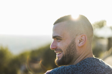 Profile of happy young man in backlight - AFVF00201