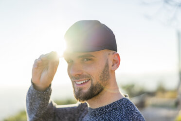 Portrait of smiling young man in backlight - AFVF00205