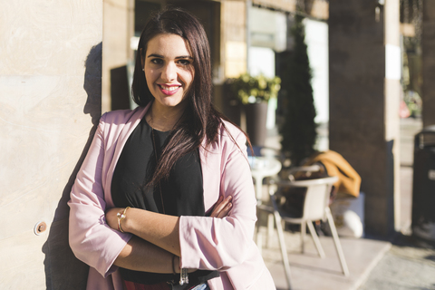 Portrait of smiling young woman in the city stock photo