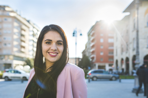 Portrait of smiling young woman in the city stock photo