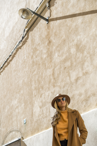 Portrait of fashionable young woman at a building stock photo