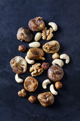 Dried figs, almonds and various nuts on dark ground - CSF28936