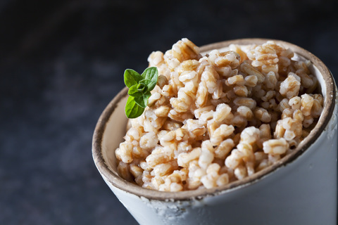 Bowl of cooked spelt grains, close-up stock photo