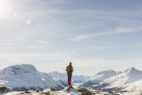 Switzerland, Engadin, hiker in mountainscape looking at view stock photo