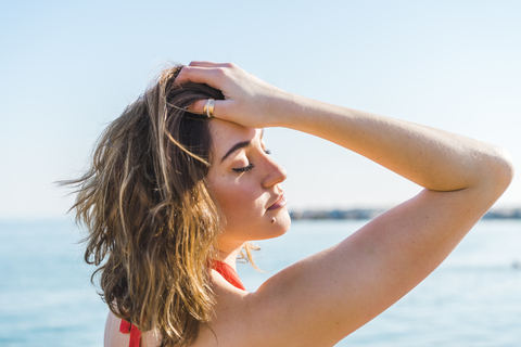 Portrait of attractive young woman on the beach stock photo