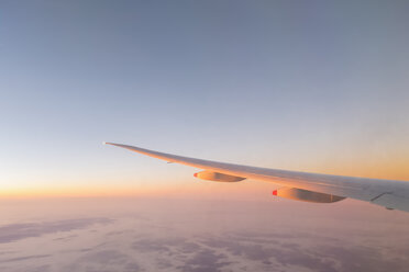 Europe, wing of an airplane with clouds at sunrise - FOF09842