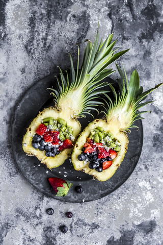 Sliced ananas with fruits, kiwi, strawberry and blueberry stock photo