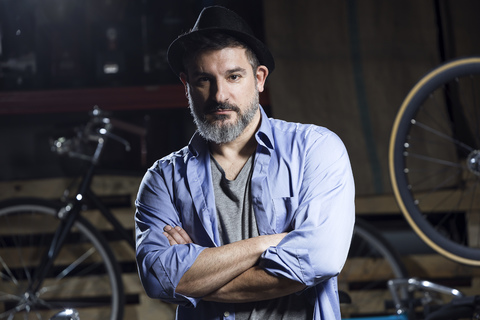 Portrait of serious man in bicycle workshop stock photo