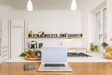 Laptop and tablet on kitchen counter - JHAF00012