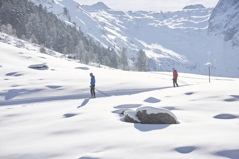 Austria, Tyrol, Luesens, Sellrain, two cross-country skiers in snow-covered landscape - CVF00159