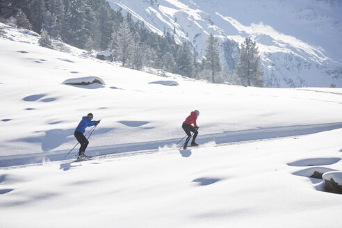 Austria, Tyrol, Luesens, Sellrain, two cross-country skiers in snow-covered landscape - CVF00162