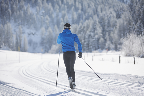 Austria, Tyrol, Luesens, Sellrain, cross-country skier in loipe in snow-covered landscape stock photo