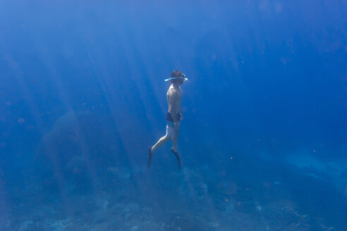 Mann mit Flossen und Schnorchel taucht unter Wasser - KNTF01028