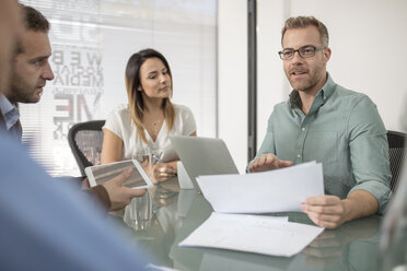 Colleagues having a meeting in office boardroom - ZEF15059