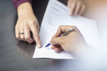 Close-up of signing a document - ZEF15083