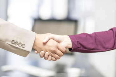 Close-up of businessman and businesswoman shaking hands - ZEF15085