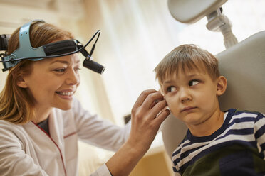 ENT physician examining ear of a boy - ZEDF01227