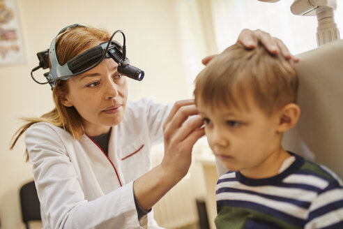 ENT physician examining ear of a boy - ZEDF01229