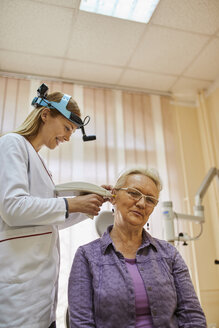 ENT physician examining ear of a senior woman - ZEDF01237