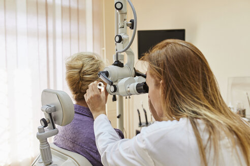 ENT physician examining ear of a senior woman - ZEDF01238