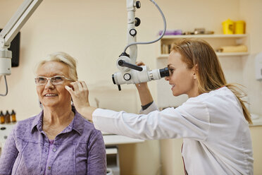 ENT physician examining ear of a senior woman - ZEDF01239