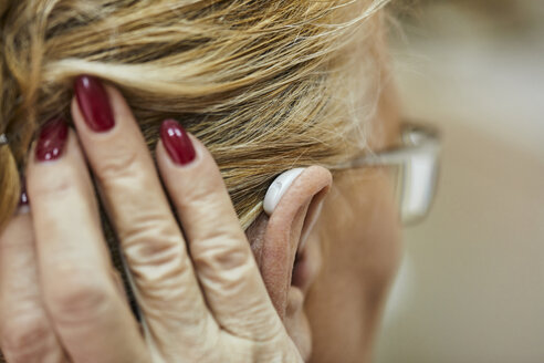 Close-up of senior woman with hearing aid - ZEDF01250