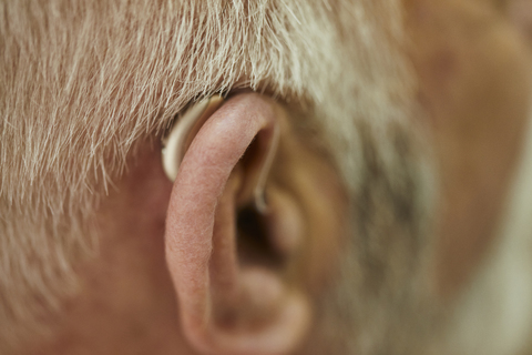 Close-up of senior man with hearing aid stock photo