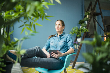 Beautiful woman in her home, decorated with plants - MOEF00886