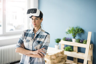 Woman using VR glasses, renovating her new home - MOEF00896