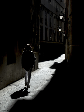 Spanien, Palma de Mallorca, Frau geht in Gasse, lizenzfreies Stockfoto