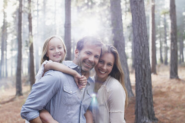 Portrait of smiling family in sunny woods - CAIF00042