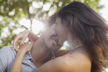 Close up of happy couple hugging - CAIF00081