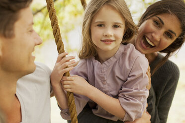 Portrait of happy family on swing - CAIF00186