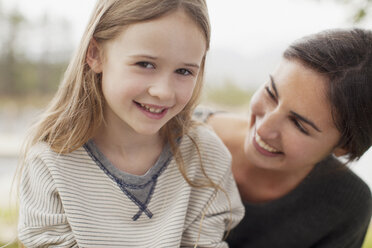 Close up portrait of smiling mother and daughter - CAIF00194