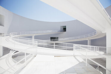 Curving elevated walkway in modern courtyard - CAIF00280