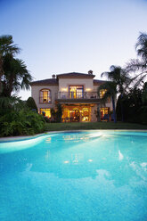 Luxury swimming pool and villa at dusk - CAIF00365