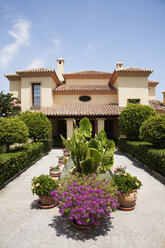 Potted plants in formal garden outside villa - CAIF00367
