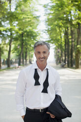 Portrait of well-dressed man in park - CAIF00499