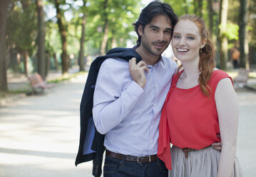 Portrait of smiling couple in park - CAIF00522