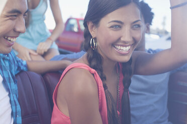 Smiling friends riding in convertible - CAIF00665